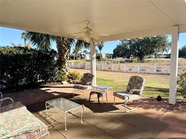 a view of a chairs and table in patio