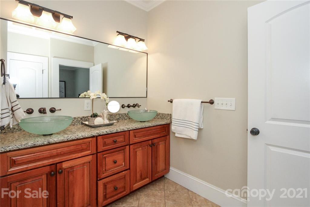 1637 Club Road Charlotte, NC 28205 - Photo 17 of 28 a bathroom with a granite countertop sink and mirror
