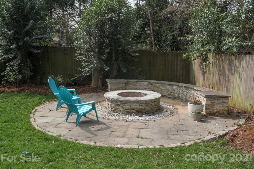 1637 Club Road Charlotte, NC 28205 - Photo 26 of 28 a view of a backyard with table and chairs potted plants and tree