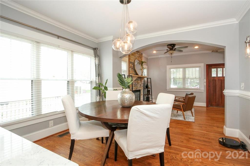 1637 Club Road Charlotte, NC 28205 - Photo 5 of 28 a view of a dining room with furniture wooden floor and chandelier