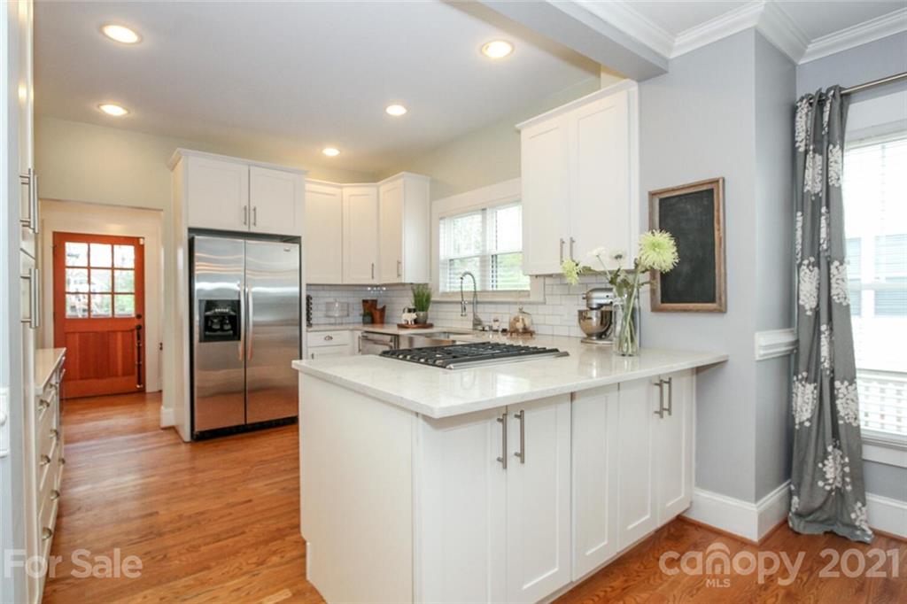 1637 Club Road Charlotte, NC 28205 - Photo 7 of 28 a kitchen with stainless steel appliances granite countertop a sink stove and refrigerator
