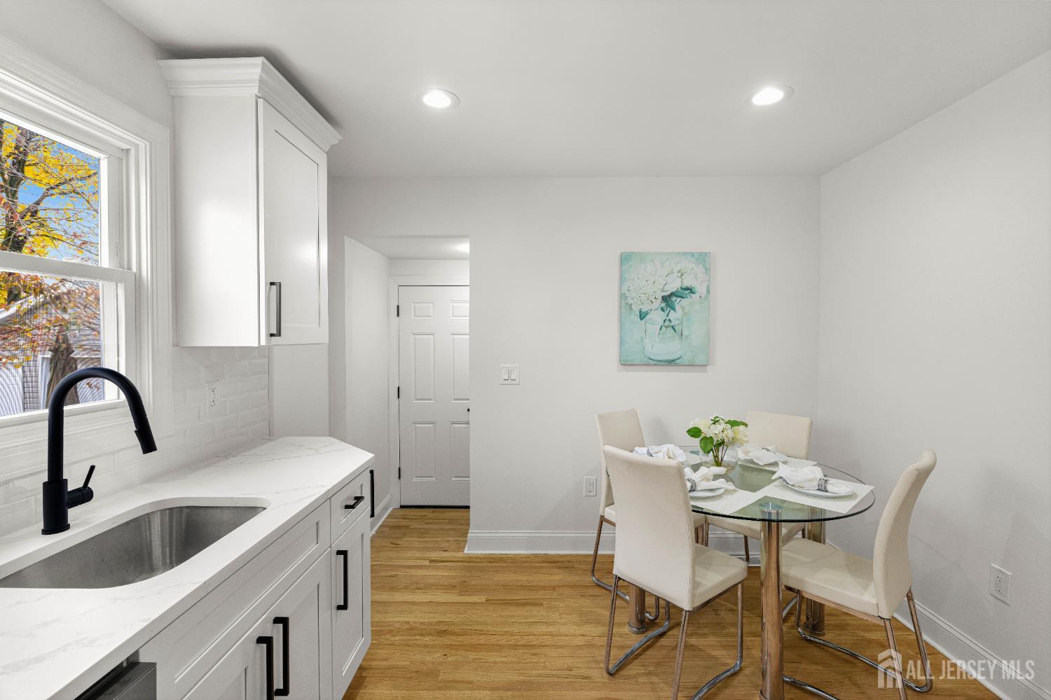 709 Front Street Dunellen, NJ 08812 - Photo 11 of 34 a kitchen with granite countertop a sink and cabinets