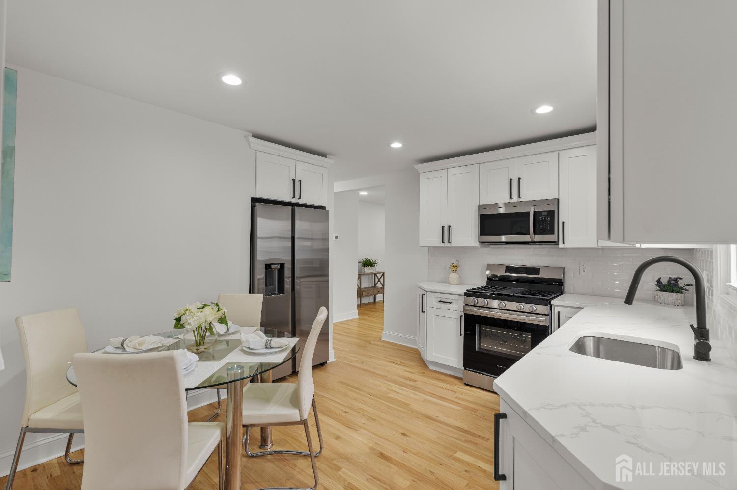 709 Front Street Dunellen, NJ 08812 - Photo 12 of 34 a kitchen with stainless steel appliances a stove a sink a microwave and a refrigerator