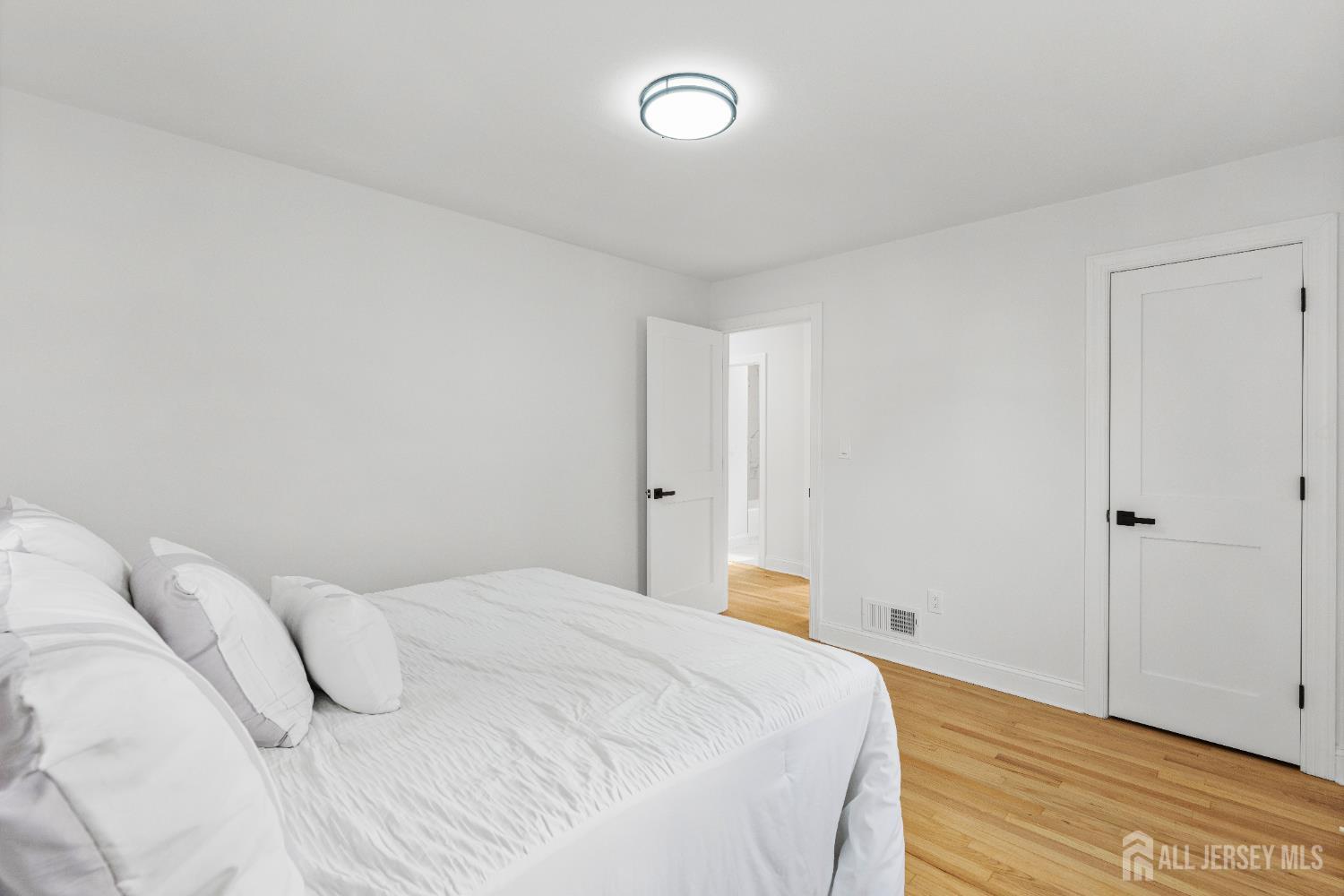 709 Front Street Dunellen, NJ 08812 - Photo 16 of 34 a bedroom with a bed and a wooden floor