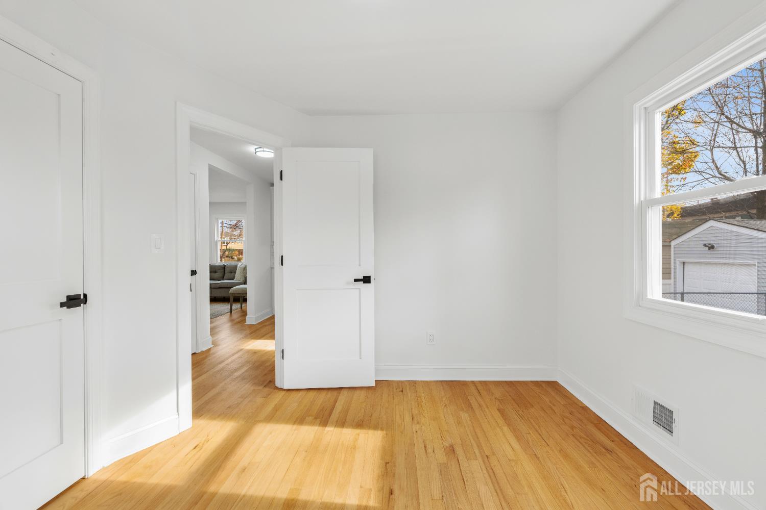 709 Front Street Dunellen, NJ 08812 - Photo 21 of 34 a view of a bedroom with wooden floor and a window