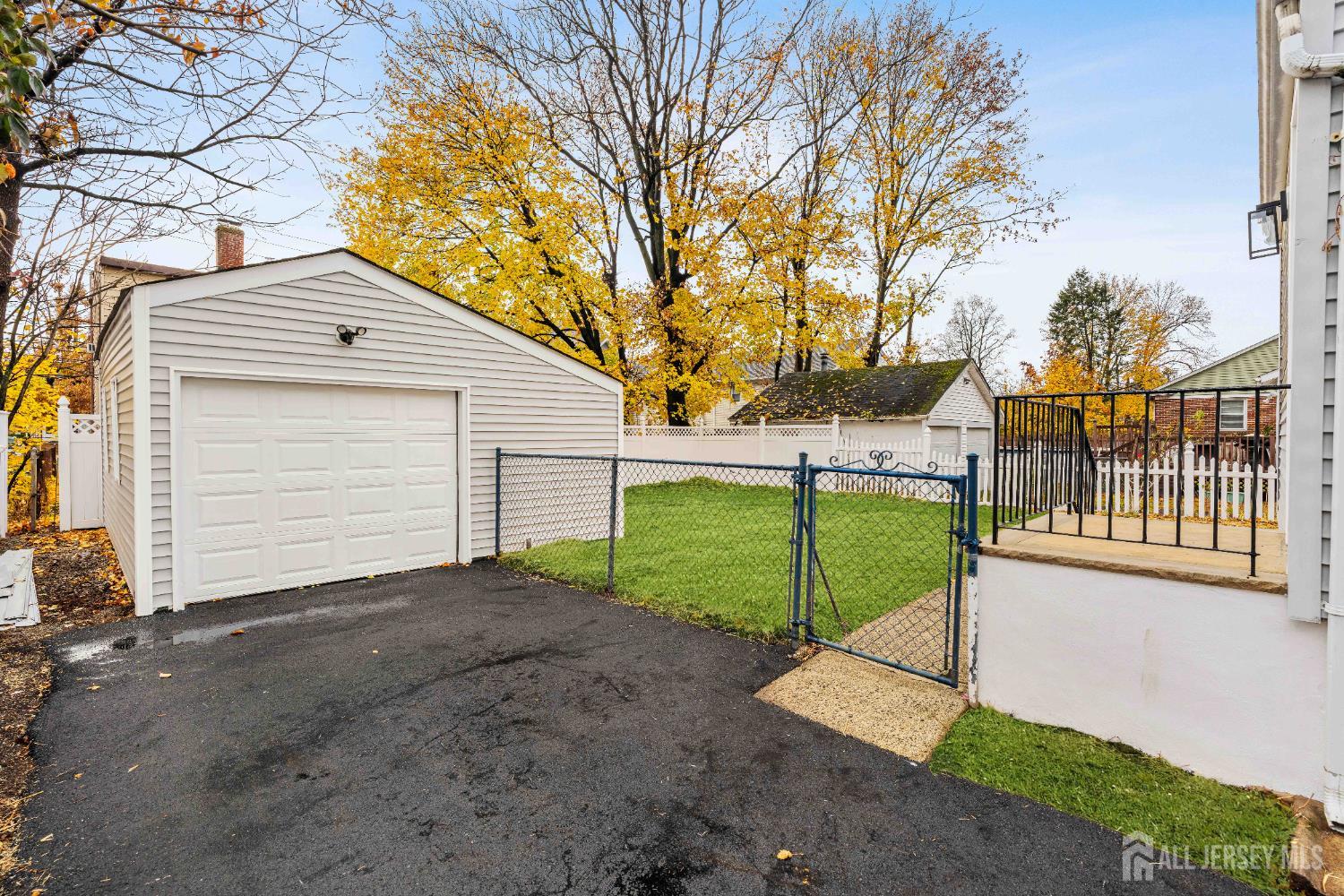 709 Front Street Dunellen, NJ 08812 - Photo 28 of 34 a view of a house with a small yard and a large tree
