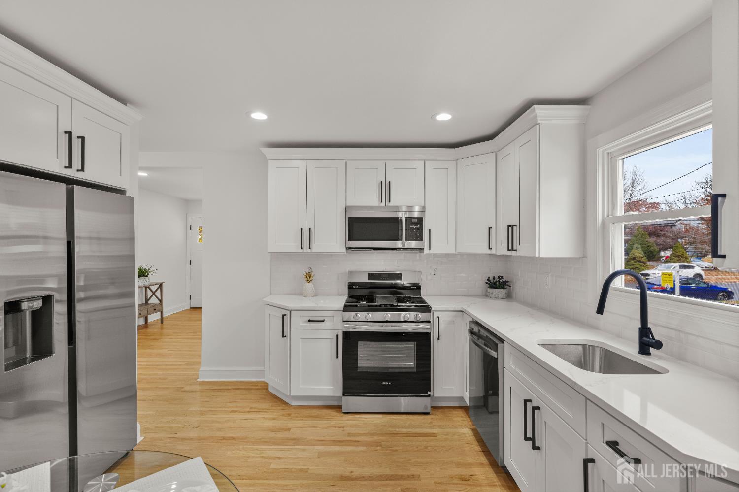 709 Front Street Dunellen, NJ 08812 - Photo 9 of 34 a kitchen with a sink stainless steel appliances and cabinets