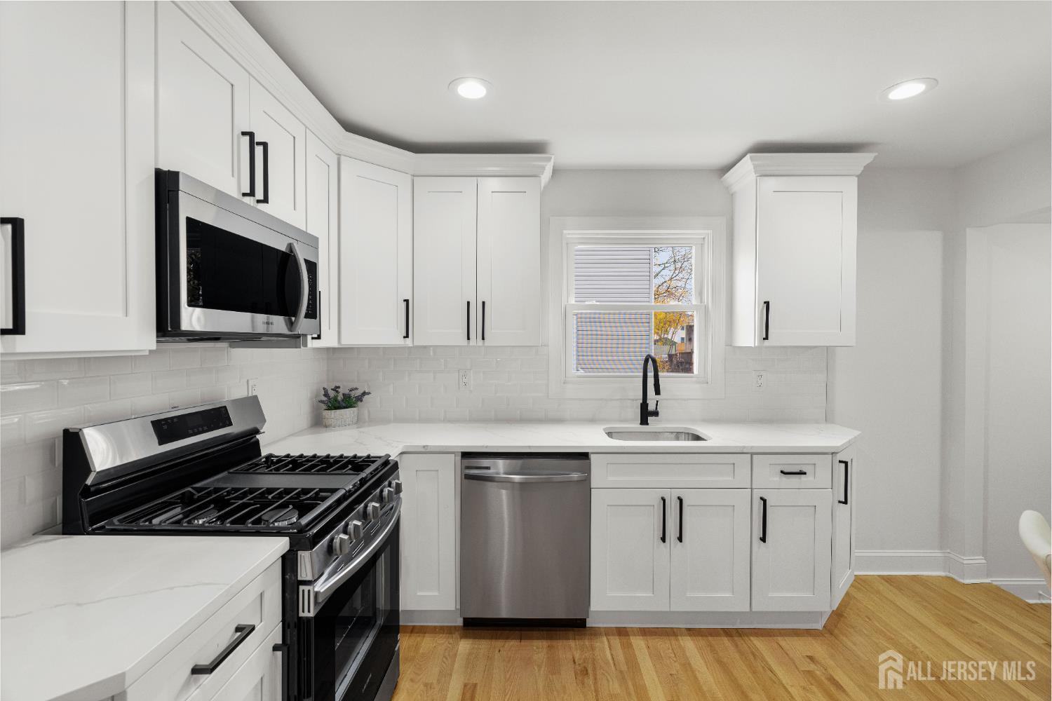 709 Front Street Dunellen, NJ 08812 - Photo 10 of 34 a kitchen with cabinets appliances and a sink