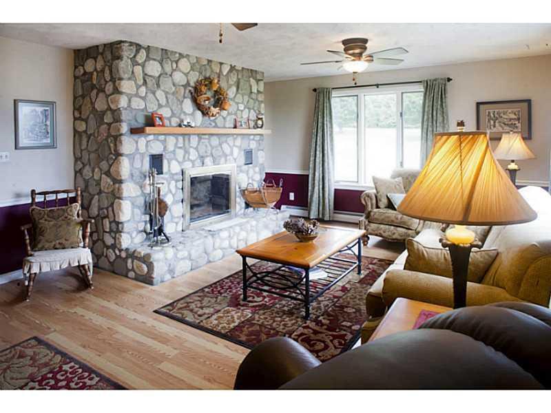 471 Libby Hill Road Palmyra, ME 04965 - Photo 6 of 35 Living Room. Features field stone...