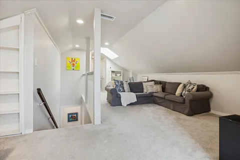 a view of a patio with couches chairs and wooden floor