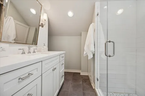 a roof deck with couches and potted plants