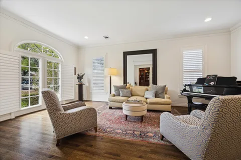 a living room with furniture and wooden floor