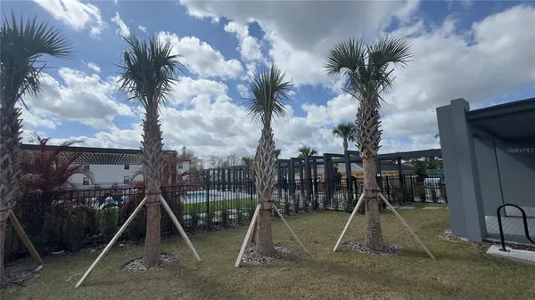 a view of a kitchen with wooden floor and electronic appliances