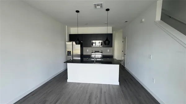 a kitchen with granite countertop a stove and a microwave