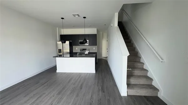 a kitchen with stainless steel appliances a refrigerator and a stove