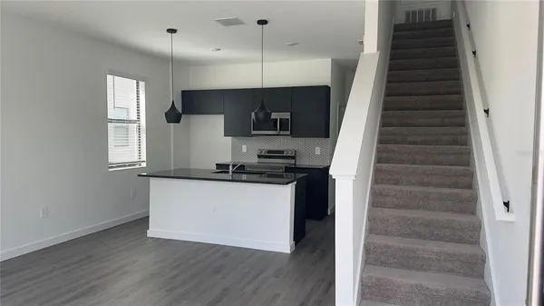 a kitchen with a sink a refrigerator and a stove