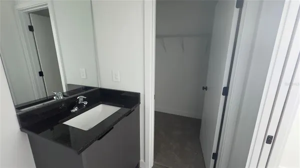 a white toilet sitting next to a bathroom sink