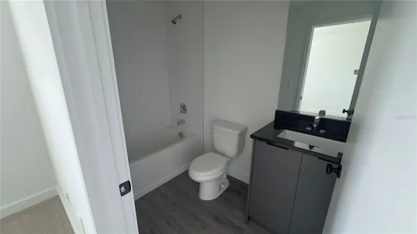 a small space with wooden floor and closet