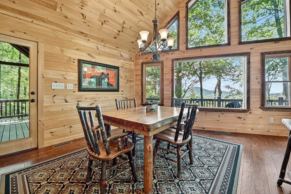 839 Green Ridge Road Blue Ridge, GA 30513 - Photo 8 of 54 a view of a dining room with furniture large windows and wooden floor