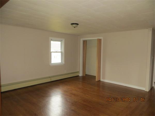 62 Chipaway Road Freetown, MA 02717 - Photo 5 of 14 an empty room with wooden floor and windows