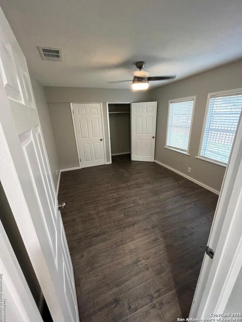 302 Ross Avenue Devine, TX 78016 - Photo 18 of 20 wooden floor in an empty room with a window
