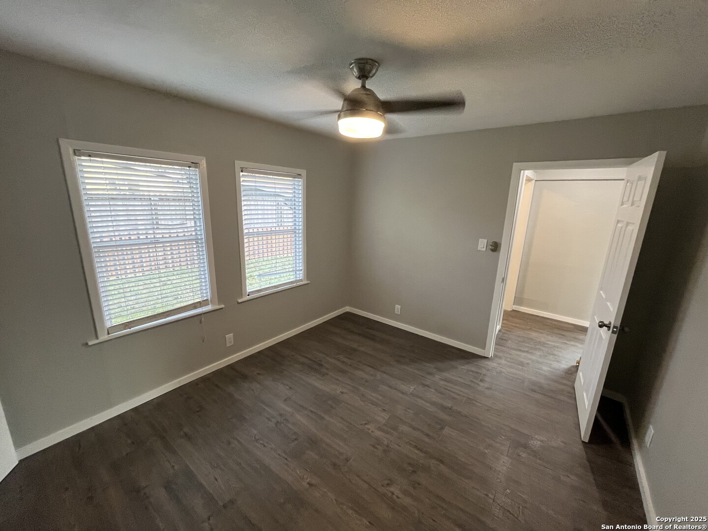 302 Ross Avenue Devine, TX 78016 - Photo 19 of 20 a view of an empty room with wooden floor and a window