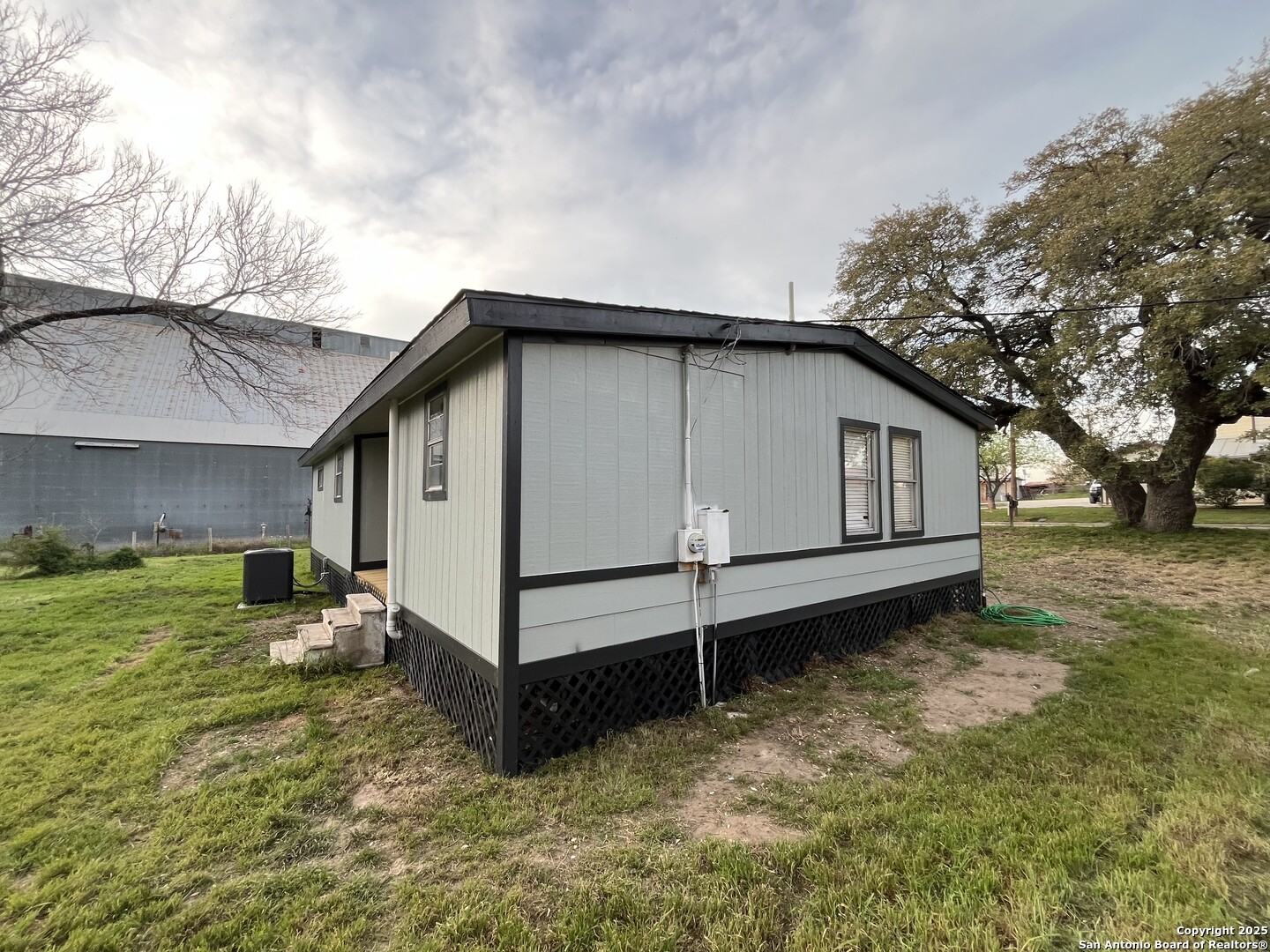 302 Ross Avenue Devine, TX 78016 - Photo 4 of 20 a view of a house with a yard