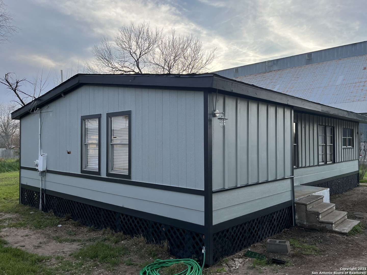 302 Ross Avenue Devine, TX 78016 - Photo 6 of 20 a side view of a house with a yard