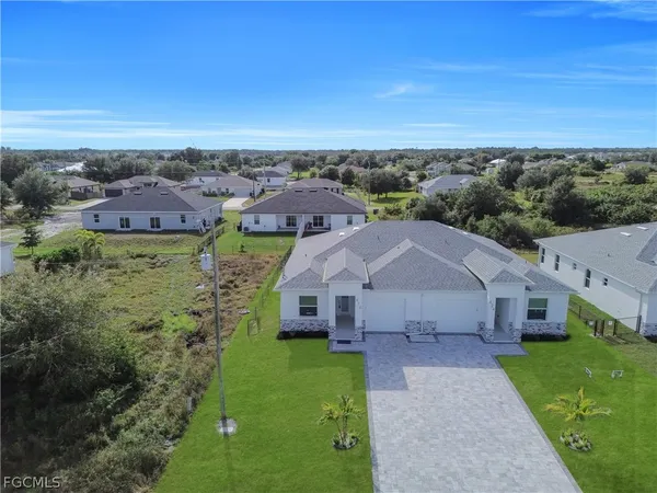 an aerial view of a house with a yard