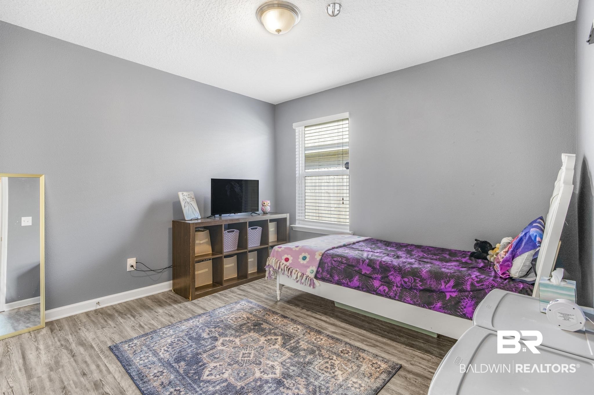 10738 Ridgeview Drive Mobile, AL 36608 - Photo 18 of 48 Bedroom featuring light wood-type flooring and a textured ceiling