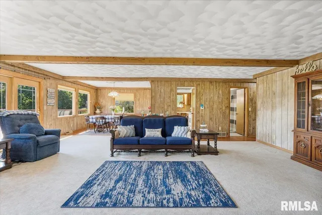 a living room with furniture rug and a table