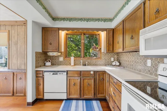 a kitchen with stainless steel appliances a table and chairs