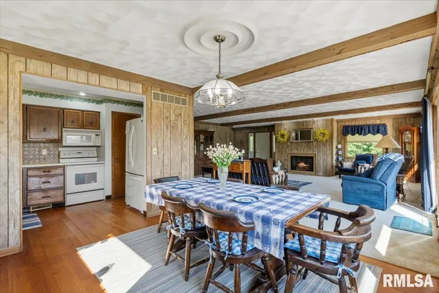 a spacious bedroom with a bed and a chandelier
