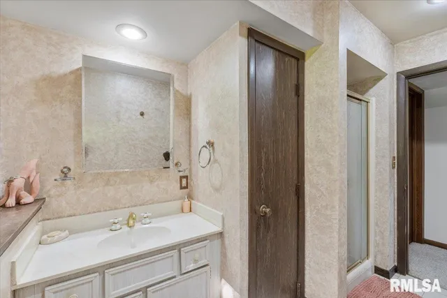 a bathroom with a sink and a large mirror