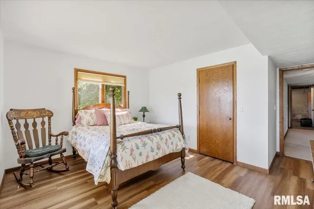 a bedroom with a bed and a large window