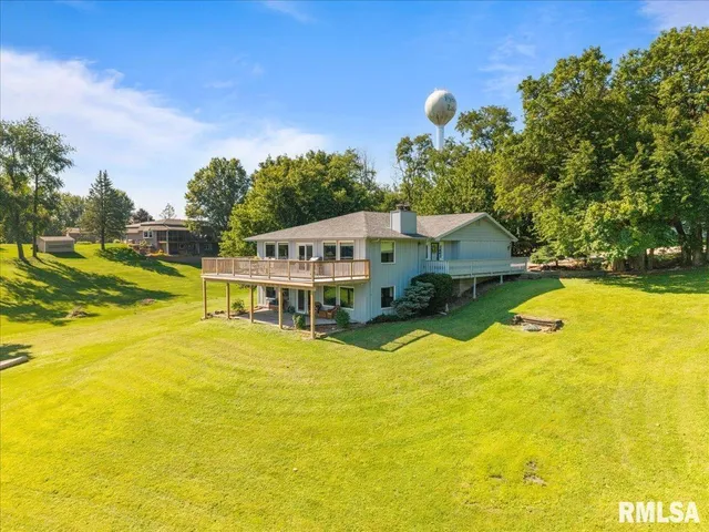 a view of a house with pool and a yard