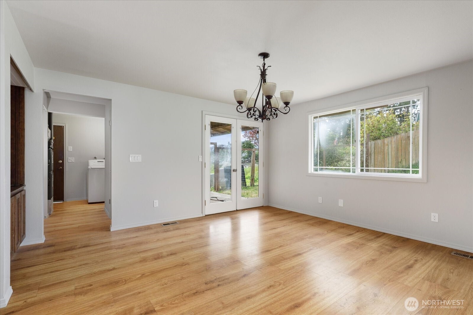 960 Southwest Capital Street Oak Harbor, WA 98277 - Photo 13 of 40 a view of an empty room with wooden floor and a window