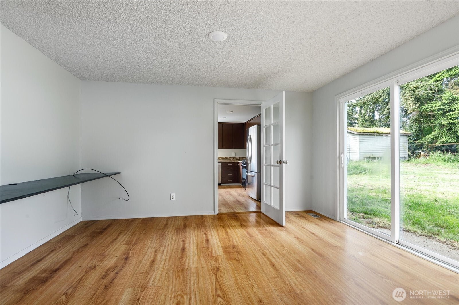 960 Southwest Capital Street Oak Harbor, WA 98277 - Photo 17 of 40 a view of empty room with wooden floor and fan