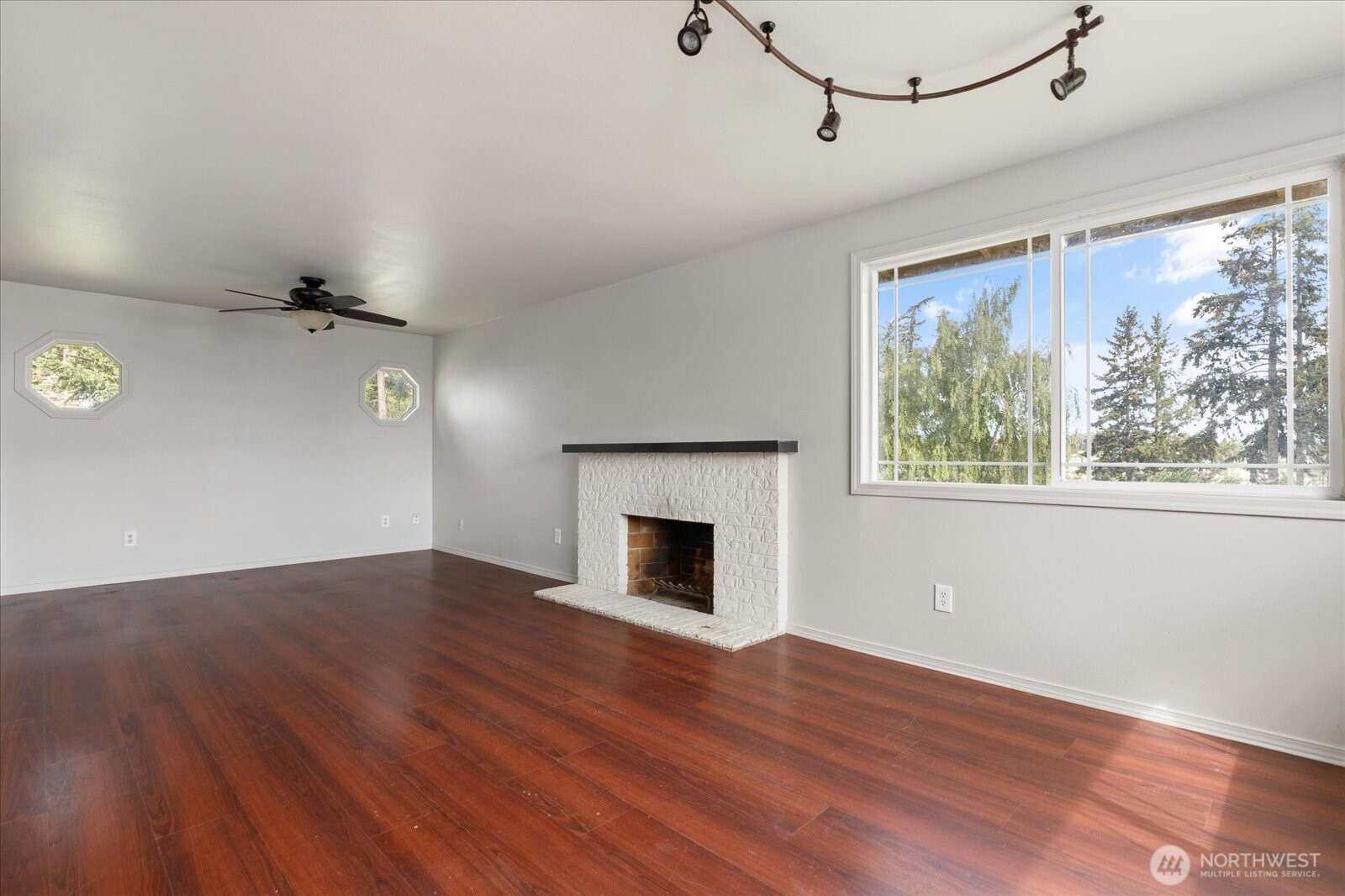 960 Southwest Capital Street Oak Harbor, WA 98277 - Photo 21 of 40 an empty room with wooden floor fireplace and windows