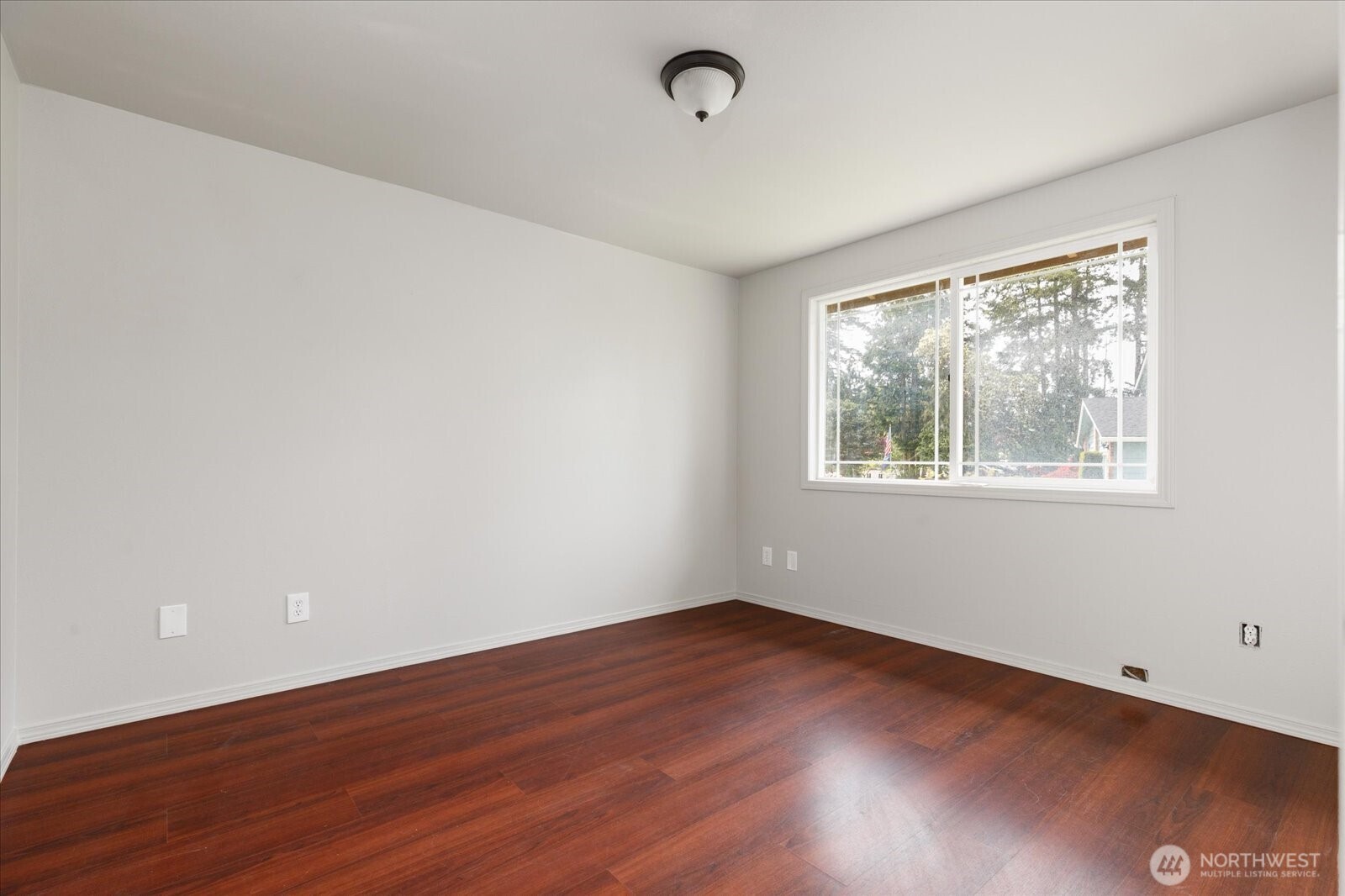 960 Southwest Capital Street Oak Harbor, WA 98277 - Photo 29 of 40 a view of an empty room with wooden floor and a window