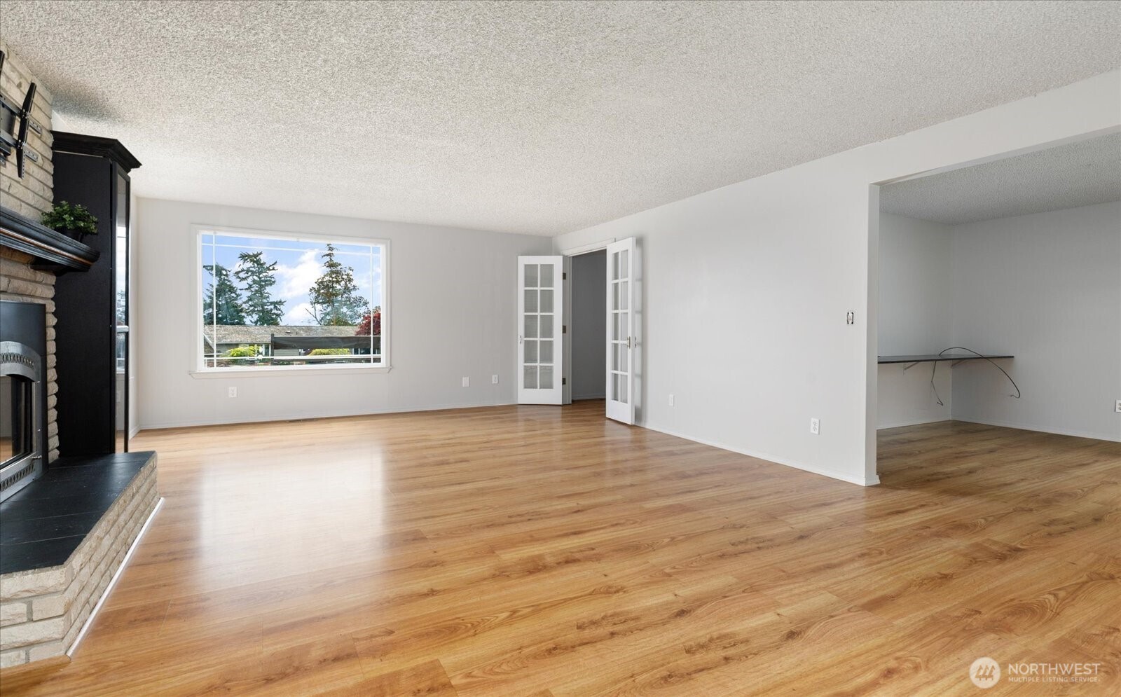 960 Southwest Capital Street Oak Harbor, WA 98277 - Photo 9 of 40 a view of an empty room with a window and a kitchen