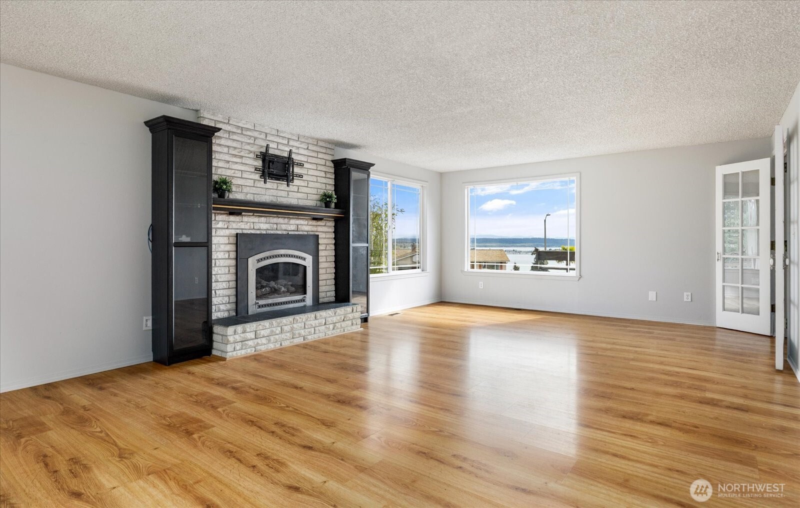 960 Southwest Capital Street Oak Harbor, WA 98277 - Photo 10 of 40 a view of an empty room with a fireplace and a window