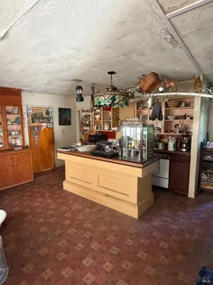 a living room with stainless steel appliances kitchen island granite countertop furniture and a kitchen view