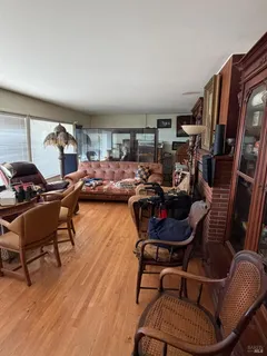 a living room with furniture and a gym machine