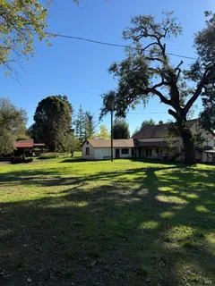 a view of a big house with a big yard