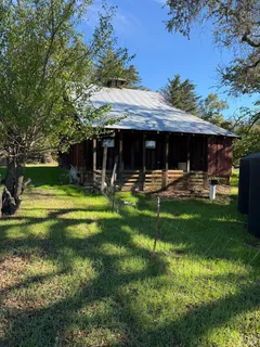 a view of a house with backyard and a patio