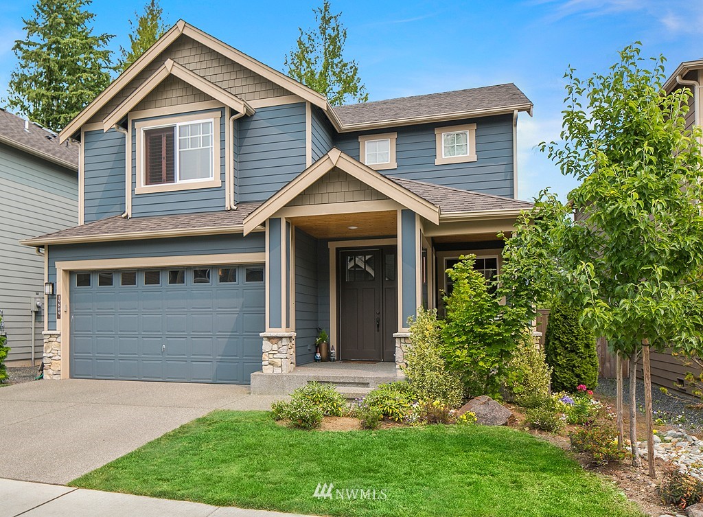 19809 3rd Avenue Southeast Bothell, WA 98012 - Photo 1 of 21 a front view of a house with a yard and garage