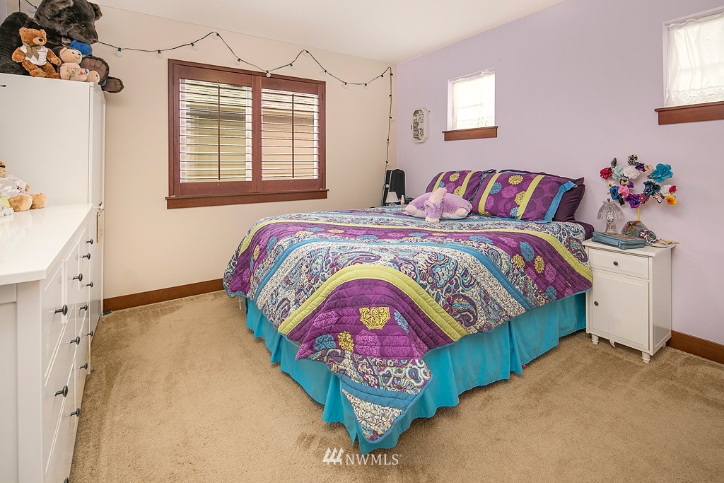 19809 3rd Avenue Southeast Bothell, WA 98012 - Photo 14 of 21 a bedroom with a bed and a painting on the wall