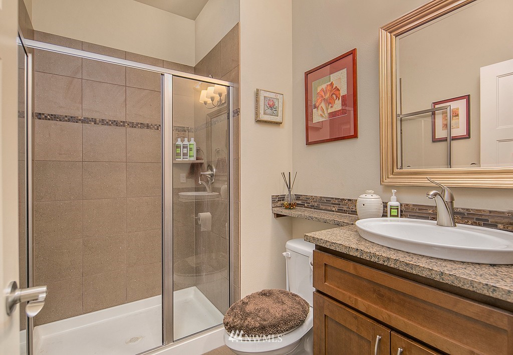 19809 3rd Avenue Southeast Bothell, WA 98012 - Photo 18 of 21 a bathroom with a granite countertop sink a toilet a shower and a mirror