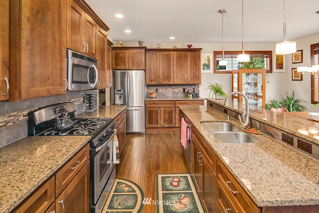 19809 3rd Avenue Southeast Bothell, WA 98012 - Photo 5 of 21 a kitchen with stainless steel appliances granite countertop a sink stove and refrigerator